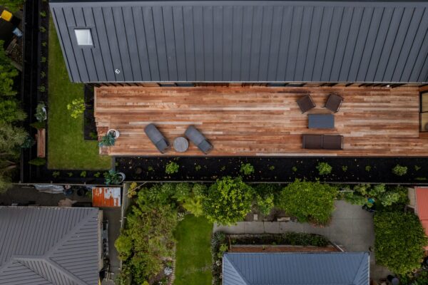Overhead view of a timber deck with outdoor furniture and surrounding garden beds