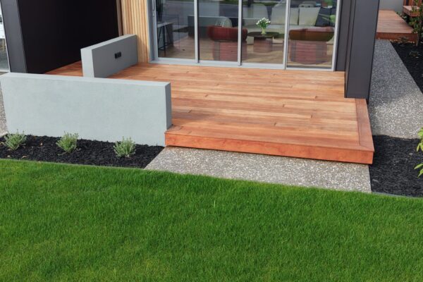 Hardwood decking with block walls and ready lawn landscaping