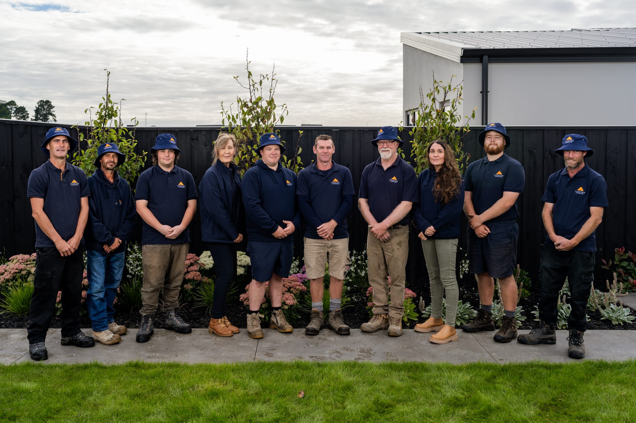 Leading Landscapes team standing together in a finished garden