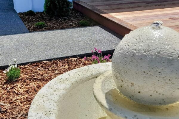 Exposed aggregate concrete, garden planting and decking